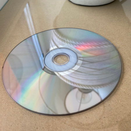 Close up of a compact disc on a table in a kitchen.