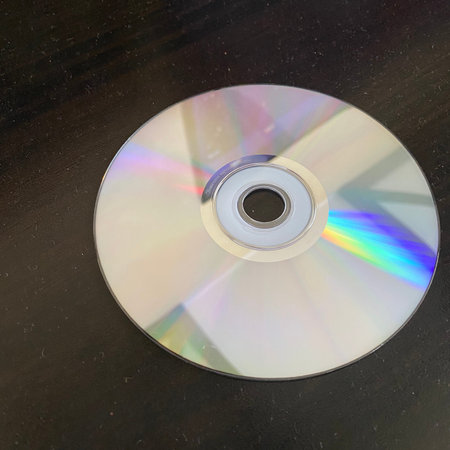 Compact disc on a black background. Close-up. Selective focus.