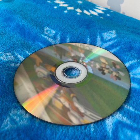 Close-up of compact disc on blue towel, shallow depth of fieldの写真素材