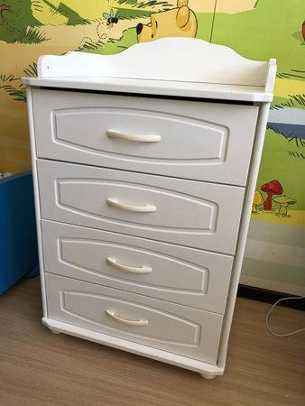 White chest of drawers in the childrens room, interior design