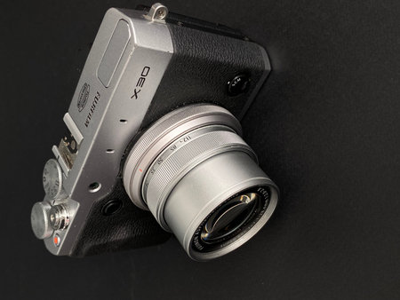 Old camera on a black background, close-up, selective focus