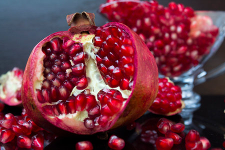 Fresh pomegranate fruit on black background. Close up.の写真素材