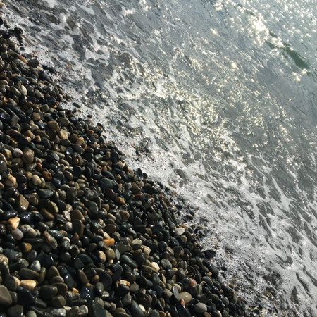 pebble beach and wave in the morning light, nature backgroundの写真素材