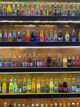 Various brands of soft drinks on shelves in supermarket.の写真素材