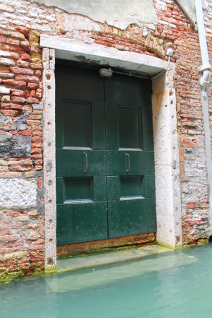 Old wooden door in Venice, Italyの写真素材