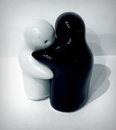 Two black and white ceramic figurines of a man and a womanの写真素材