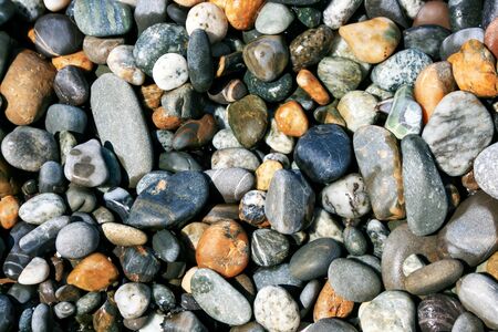 Abstract texture with pebbles in the water on the sea coastの写真素材