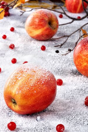 Striped apples sprinkled with powdered sugar. The dish simulates apples in the snowの写真素材