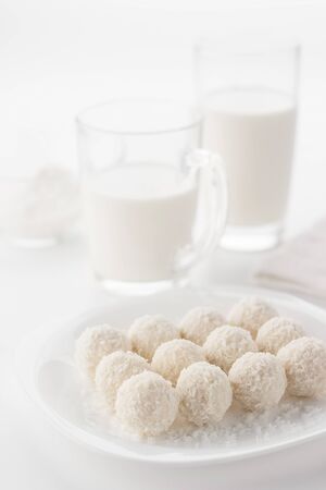 White small cakes sprinkled with coconut shavings.の写真素材