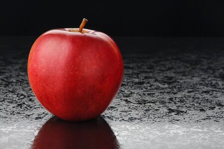 Red apple and marmalade on a black backgroundの写真素材