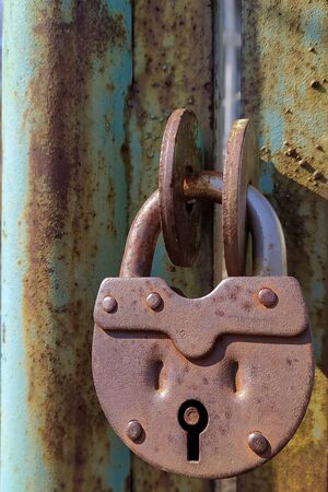 an old, rusty padlock on the gateの写真素材