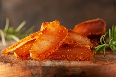 Seasoned chicken with a branch of rosemary on a cutting Boardの写真素材