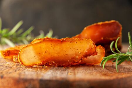 Seasoned chicken with a branch of rosemary on a cutting Boardの写真素材