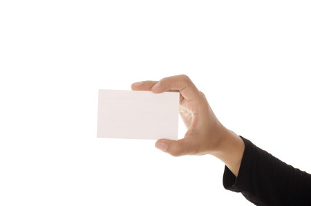 Female hand holding paper card, isolated on white backgroundの写真素材