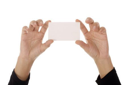 Female hand holding paper card, isolated on white backgroundの写真素材