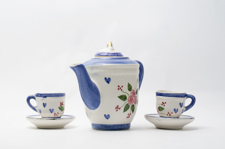 Porcelain teapot and teacup on white backgroundの写真素材