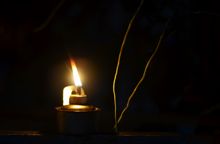 Traditional kerosene lamp light  also known as pelita isolated in a dark background.の写真素材