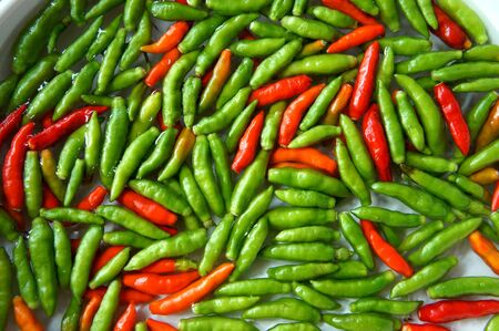 Red and green chili at a market.の写真素材
