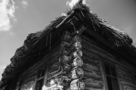 old shabby wooden house with broken roofの写真素材
