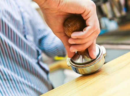barista presses the Holder to press the coffee in the holderの写真素材