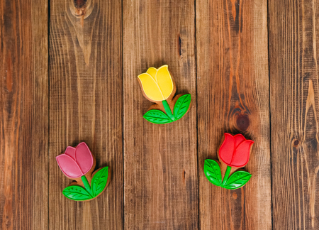 tulip flowers biscuits with colored glaze in the center on a wooden background threeの写真素材