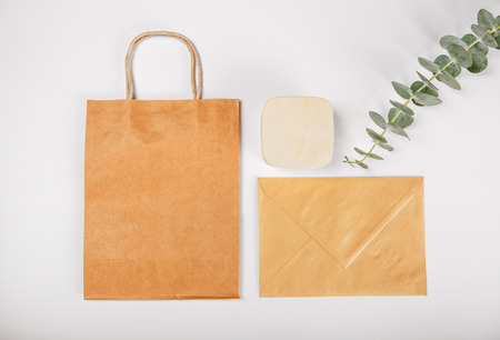 Gift's set with Brown paper bags, wooden box and envelope isolated on white backgroundの写真素材