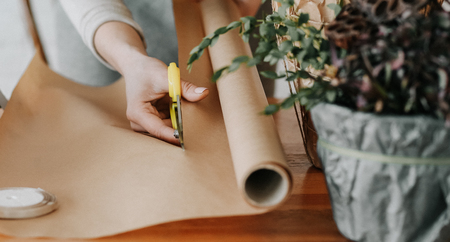 woman florist collects a bouquet decorates from different flowersの写真素材