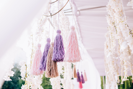 Decorations with pompons made of thread and fabric in the natureの写真素材