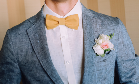 elegant groom men in grey jacket with rose buttonniere の写真素材