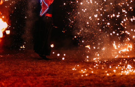 performance outside fire show in the dark with fire sparks and smoke