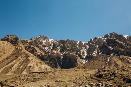 large gorge and high mountains with snow on the peaks