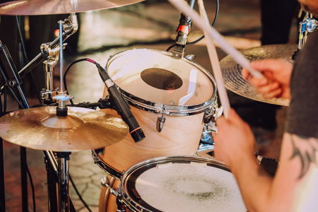 drummer with chopsticks playing instruments at a concertの写真素材