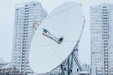 satellite dish industrial on the roof of the buildingの写真素材