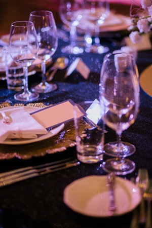 decorations for a holiday in a restaurant with flowers and glasses,cards, inscription, invitation