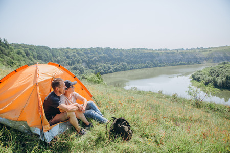 overnight family in a tent in the wild and dawn by the river with a beautiful sceneryの写真素材