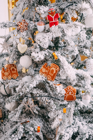 decorations on Christmas tree with snow Christmas cookies with icing in the form of an angel trainの写真素材