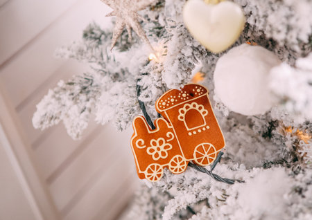 decorations on Christmas tree with snow Christmas cookies with icing in the form of an angel train