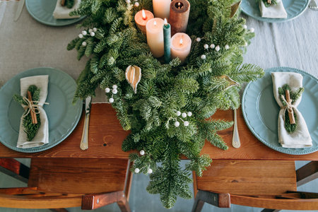 festive decorations and table setting inside the room with the Christmas tree and garlands