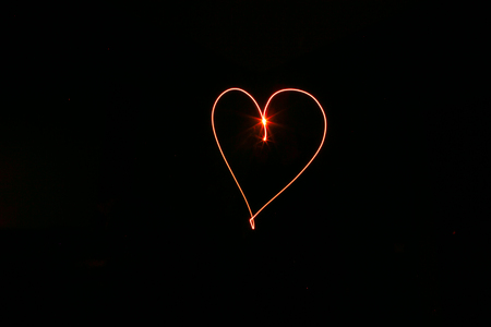 long exposure red heart on a black backgroundの写真素材
