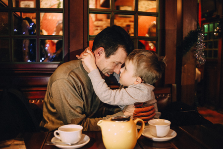 family child love happy in a cafe on holiday christmas eveningの写真素材