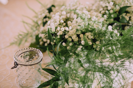 flowers white jasmine and greens asparagus for a bouquet and a glass vaseの写真素材