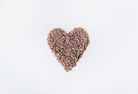 heart decorated from flowers isolated on a white background in the centerの写真素材