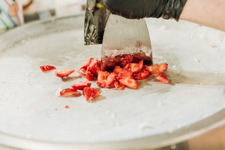 cooking dessert from fresh strawberries cutting into piecesの写真素材