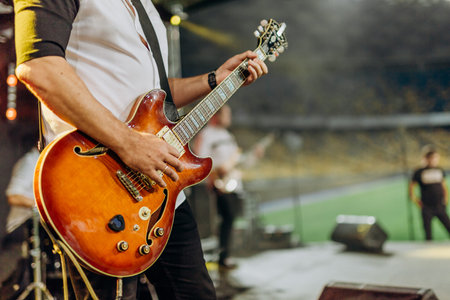 rock musician guitar player on stage stadium performance band
