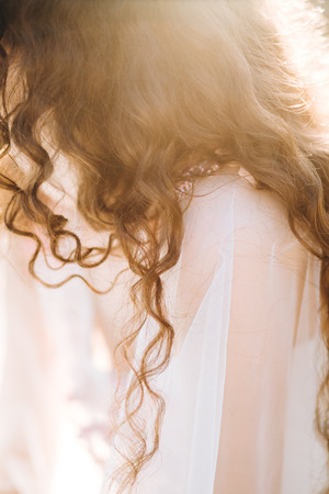 hair girl in a light dress summer sun raysの写真素材