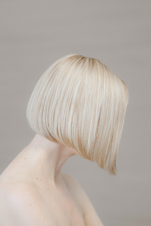 girl blonde face body morning in the bedroomの写真素材