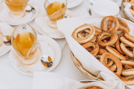 food on the table bagels and honey in a bowl for teaの写真素材