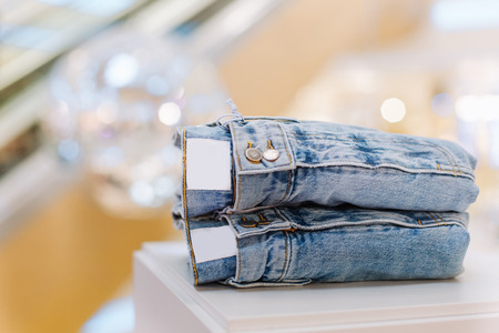 sale assortment denim collection on the stand in a stylish boutique shop selectionの写真素材