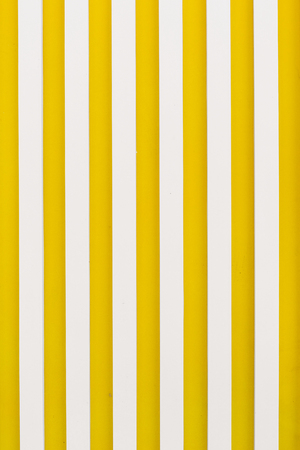background texture graphics vertical stripes yellow white wallの写真素材