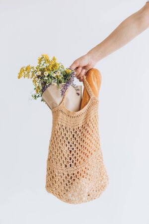 woman shopping eko style string bag mesh with products vegetables season vitaminsの写真素材